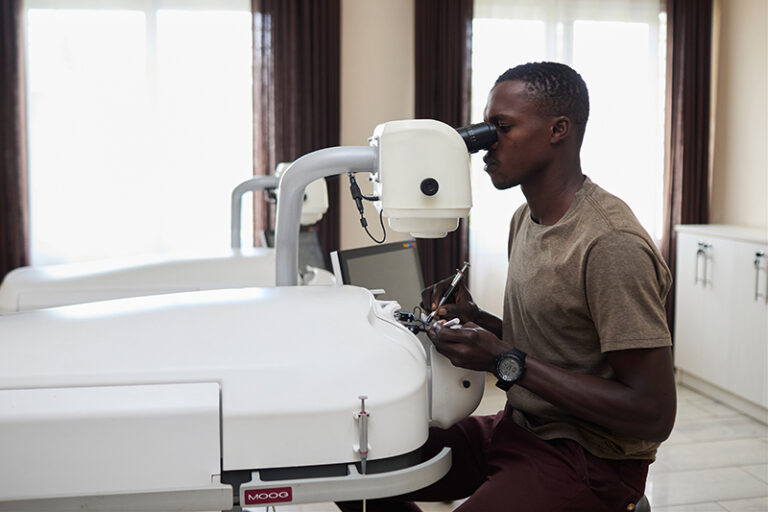 Surgeon practicing cataract surgery on a HelpMeSee simulator.