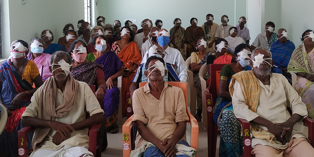 A group of cataract patients waits together before receiving sight-restoring treatment.